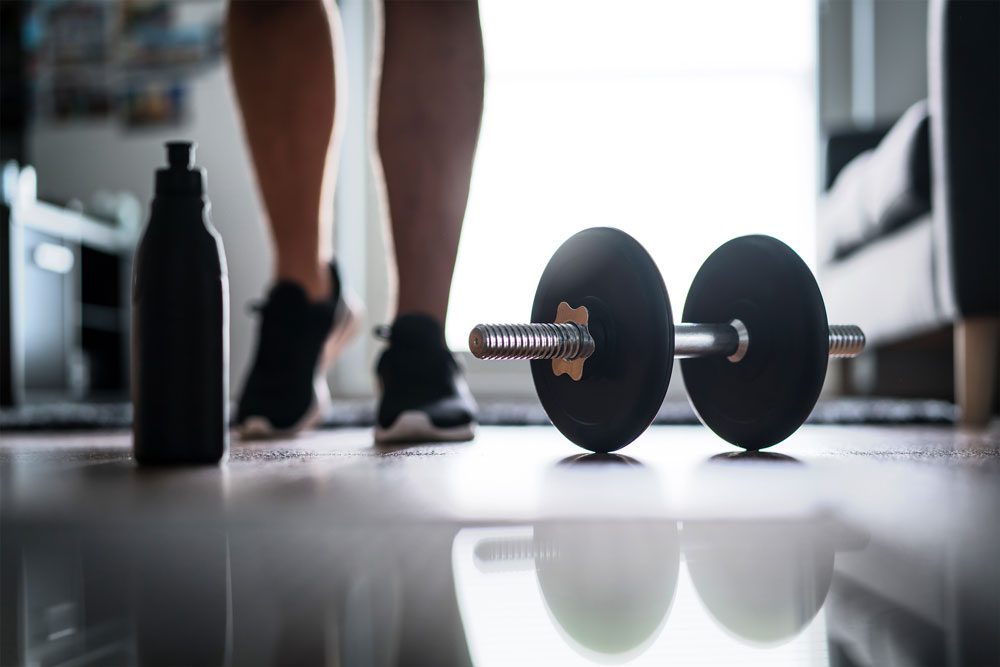 fitness enthusiast with dumbbell and water bottle